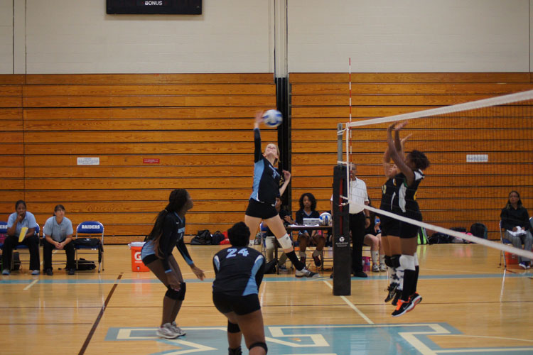 The volleyball team blocks the Clippers Monday night.