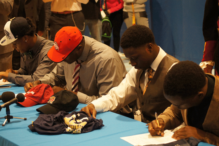 Eleanor Roosevelt Seniors sign to their future colleges on Wednesday February 4, 2015. (From right, Mike Mofor, Louie Akuffo, Isaiah Prince, and Quinlen Dean)