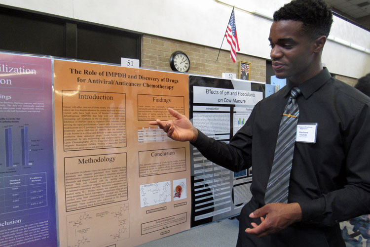 Senior Victor Olufade is among the many RP students that did a yearlong research project to fulfill their science and technology requirement. Picture above,  he shares and explain his project in the RP poster session.  