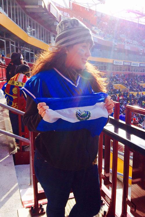 Liliana Merlos with the flag of El Salvador, her home country