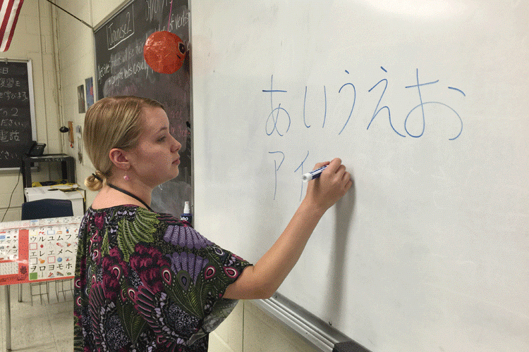 Ms. Amanda Omatsu writing Japanese letters on the board