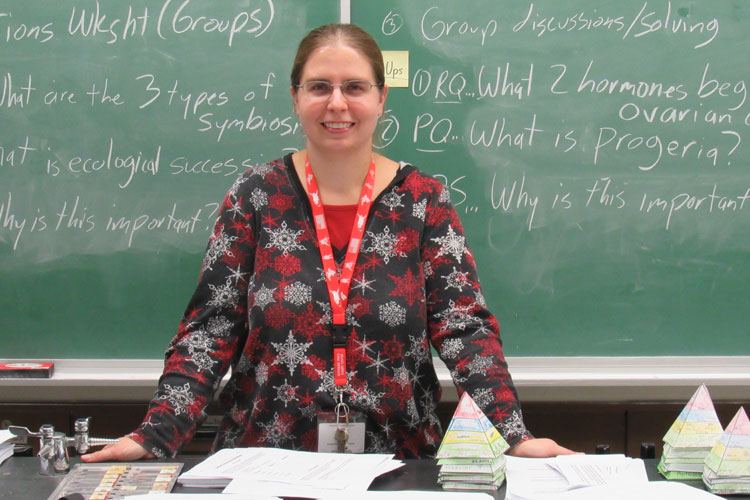 Ms. Komar at the front of her classroom 