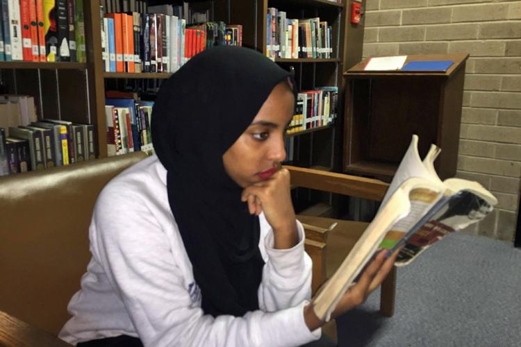 Sophomore Muna Hassen reading Black Boy in the library
