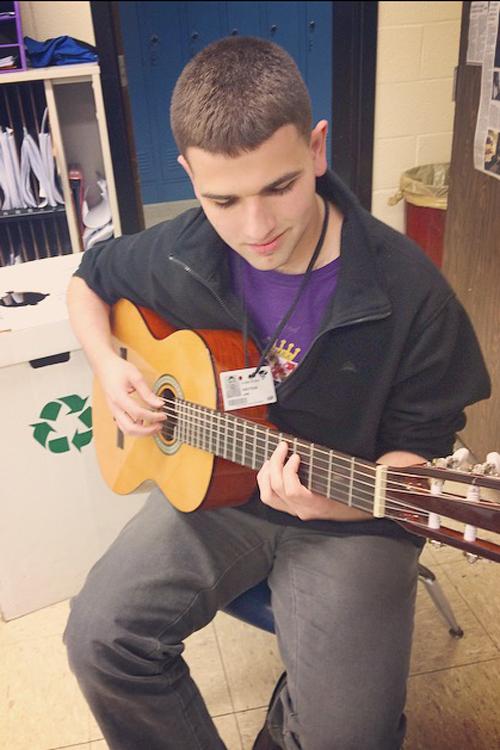 Senior Jan Knutson plays his instrument of choice, the guitar. 