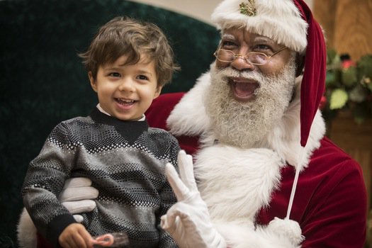 Larry Jefferson, Mall of Americas first black Santa, listening to a childs wish list for Christmas. 