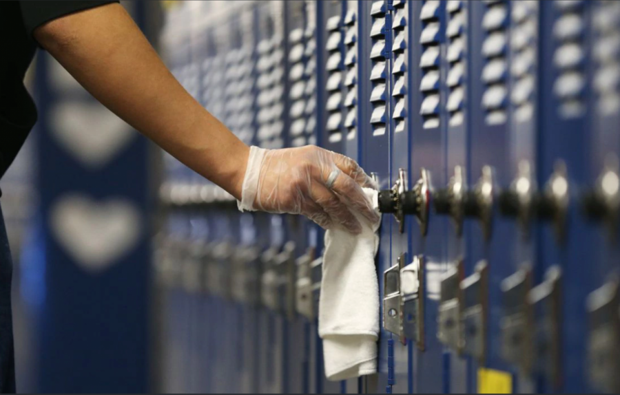 A custodian sanitizing lockers.