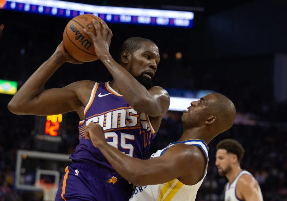 Phoenix Suns forward Kevin Durant looks to drive over Golden State Warriors guard Chris Paul during their season-opening game on Oct. 24, 2023, at Chase Center in San Francisco. (D. Ross Cameron/USA TODAY Sports) 