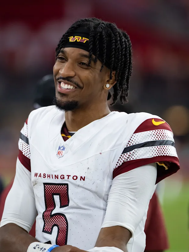 Jayden Daniels smiles after the game against the Arizona Cardinals.