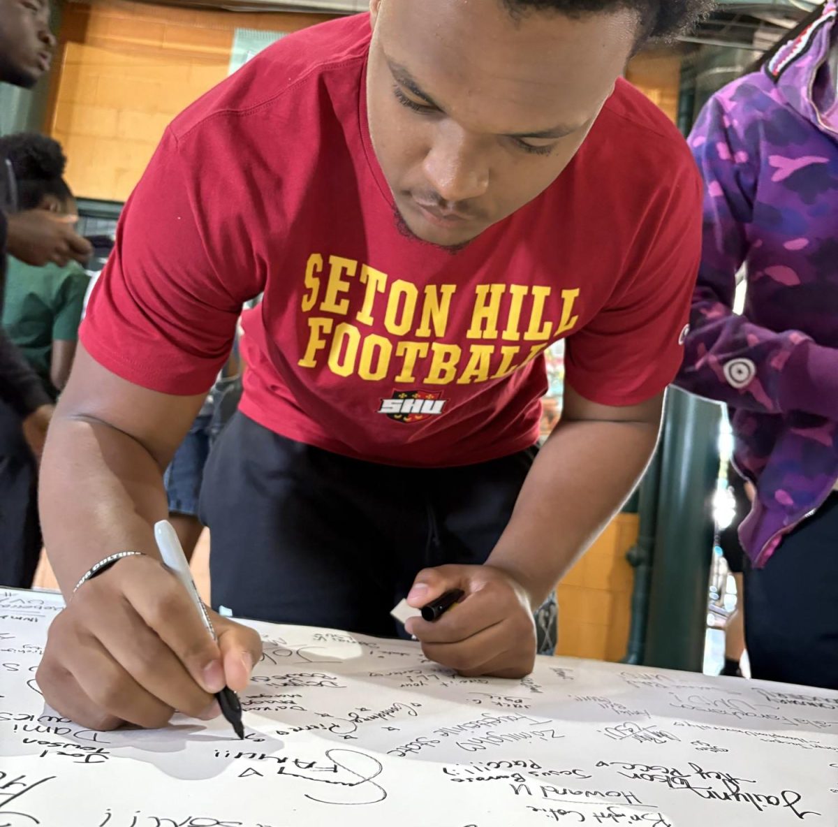 ERHS students sign their name off in a poster to share their post-graduation plans. 