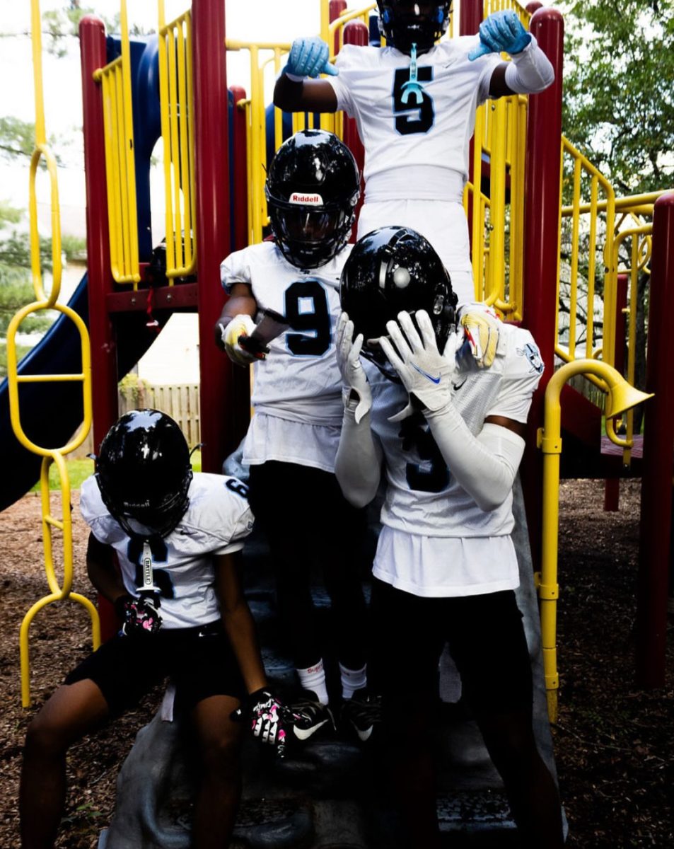 Raiders pose at a playground.