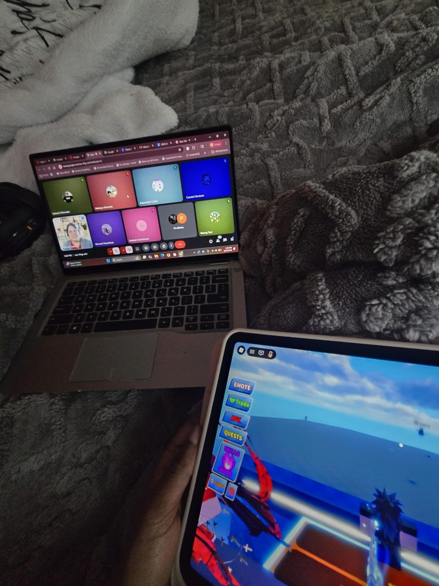 Mercy Tazi playing on her tablet while her google meet is frozen