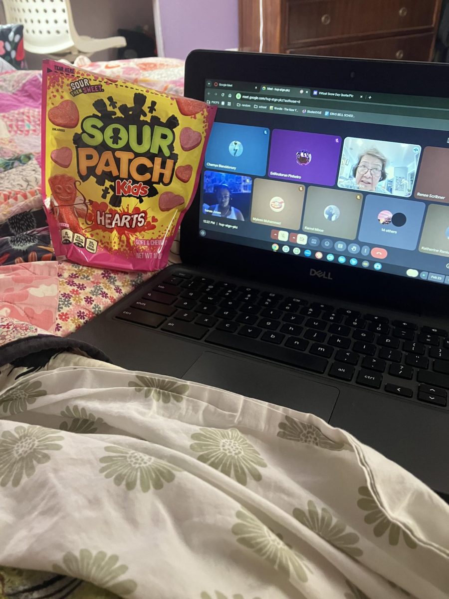 Kate Rankel’s virtual learning set up, in her bed with her computer and candy.