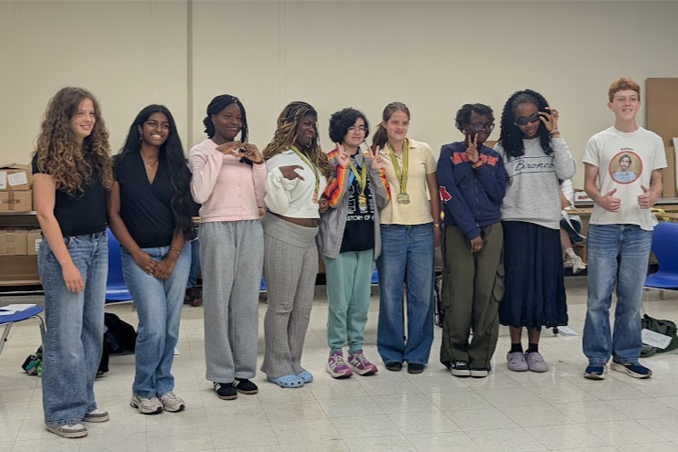 NEHS Spelling Bee contestants group photo. Left to right: Nora, Roshan, Esther, Corrine, Talika, Beatrice, Joy, Morella, & Louis. 
